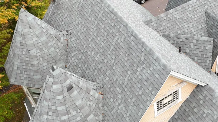 The same roof before replacement, with worn gray shingles