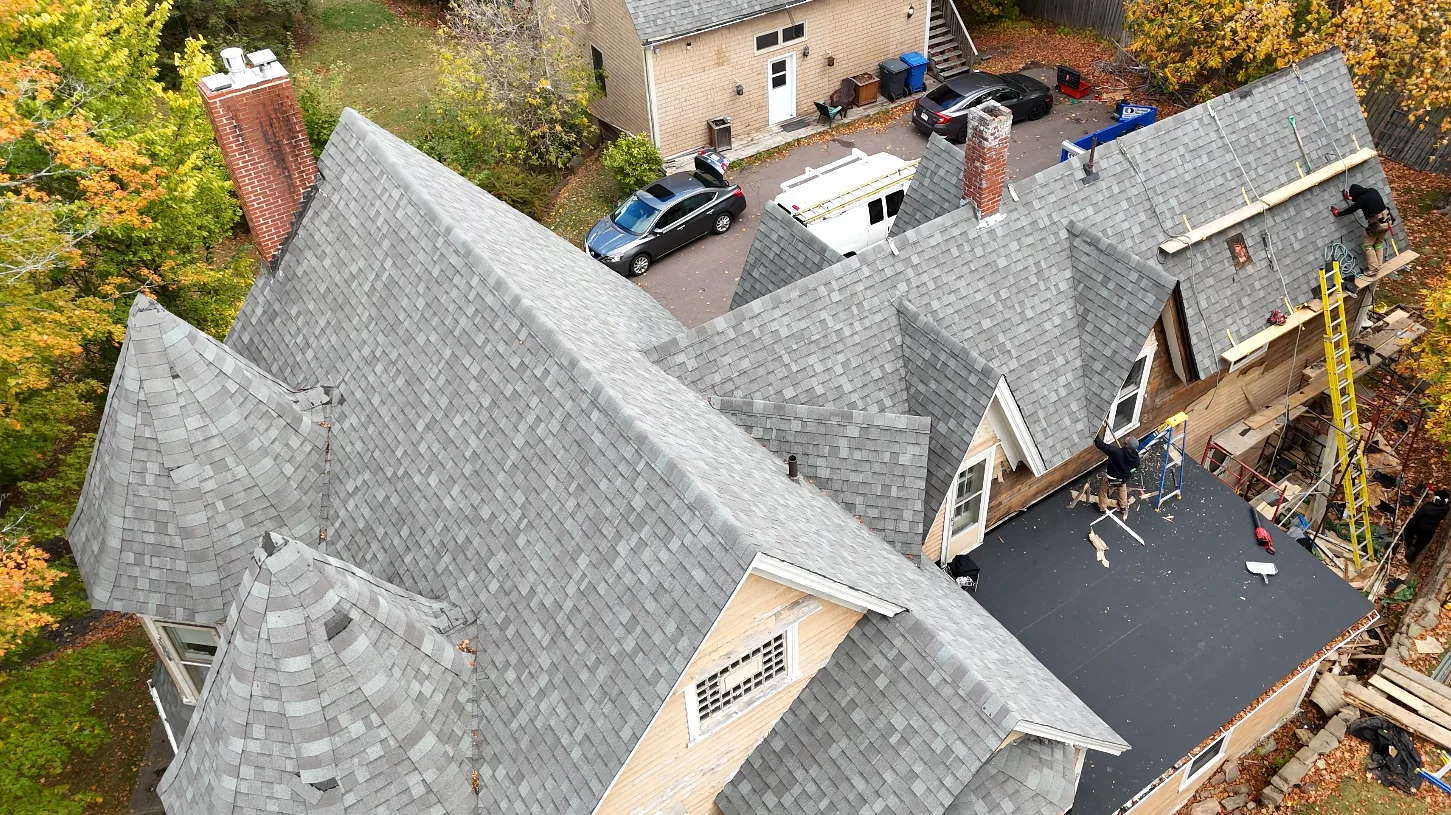 The same Sackville roof before replacement, worn gray shingles, photographed by drone in the fall